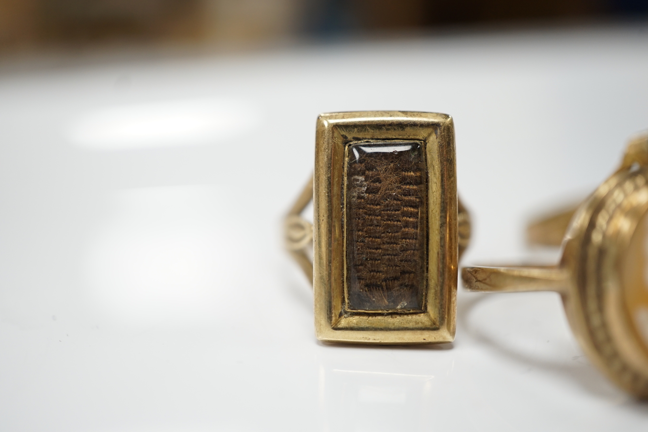 Two 19th century yellow metal mourning brooches, now with shanks converted to dress rings and two other 9ct rings.